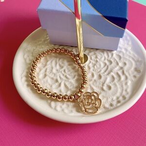 New in box. Gorgeous stretchy beaded bracelet with camellia charm